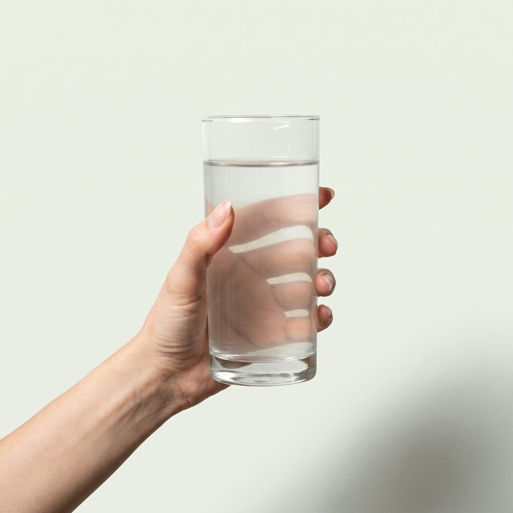 A hand holding the finished glass
